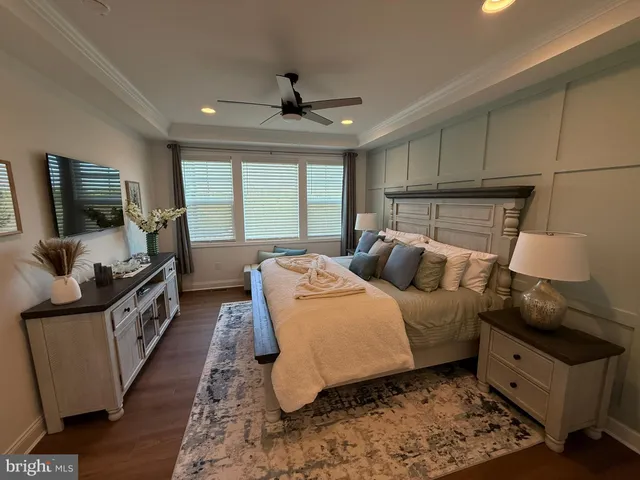 a bed room with furniture and a flat screen tv
