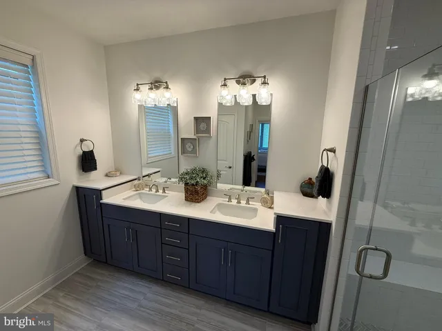 a bathroom with a double vanity sink and mirror