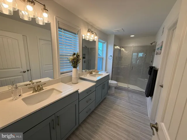 a bathroom with a double vanity sink and mirror