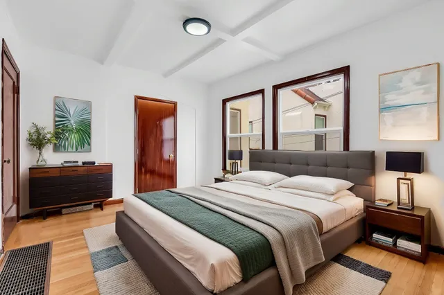 a bedroom with a bed and a couch