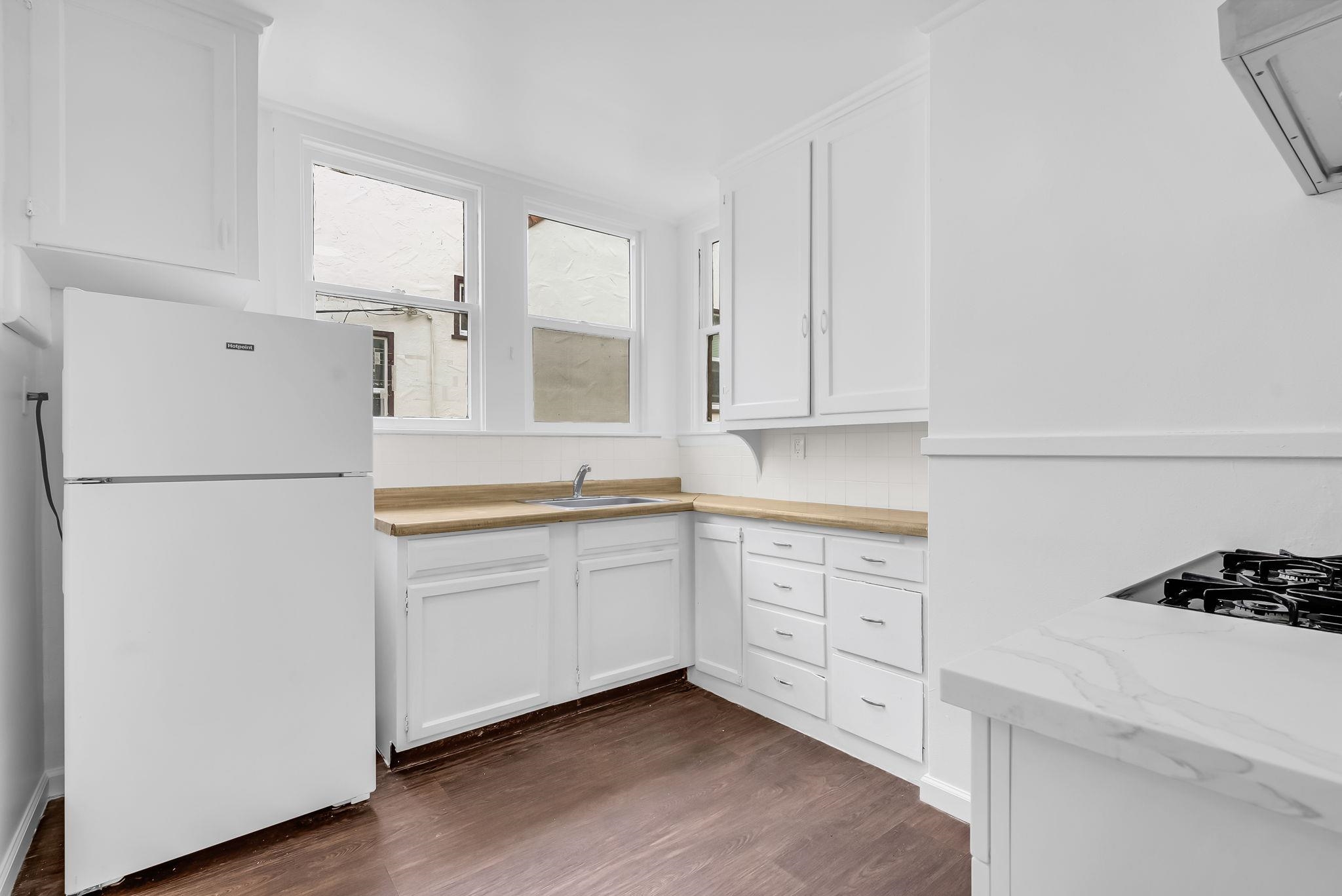 2340 Virginia Street Berkeley, CA 94709 - Photo 23 of 60 a kitchen with white cabinets and white appliances