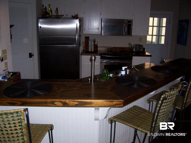 25773 Canal Road, Unit 16 Orange Beach, AL 36561 - Photo 4 of 12 SS appliances and wooden countertop--gives it a comfortable feel and great for entertaining