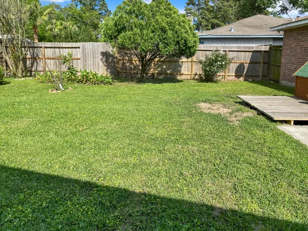 a view of a house with yard and a garden