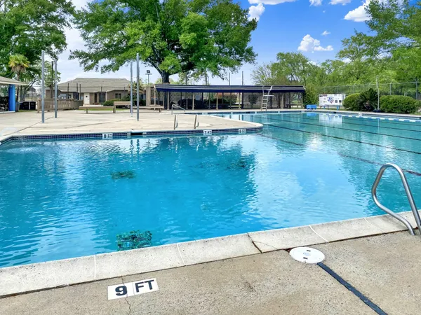 a view of a swimming pool with outdoor seating