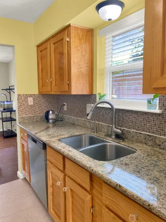 a kitchen with granite countertop a sink and a window