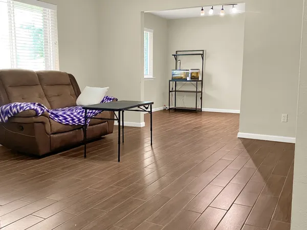 a living room with furniture and wooden floor