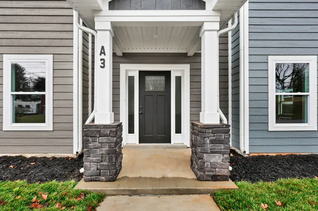 a front view of a house with a garden