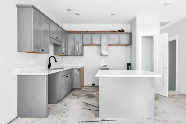 a kitchen with a sink a stove and cabinets