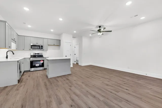 a view of kitchen with sink microwave and refrigerator