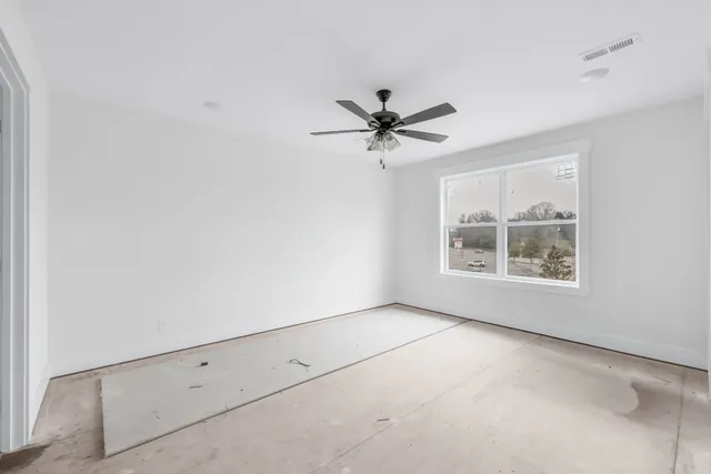 a view of an empty room with a window