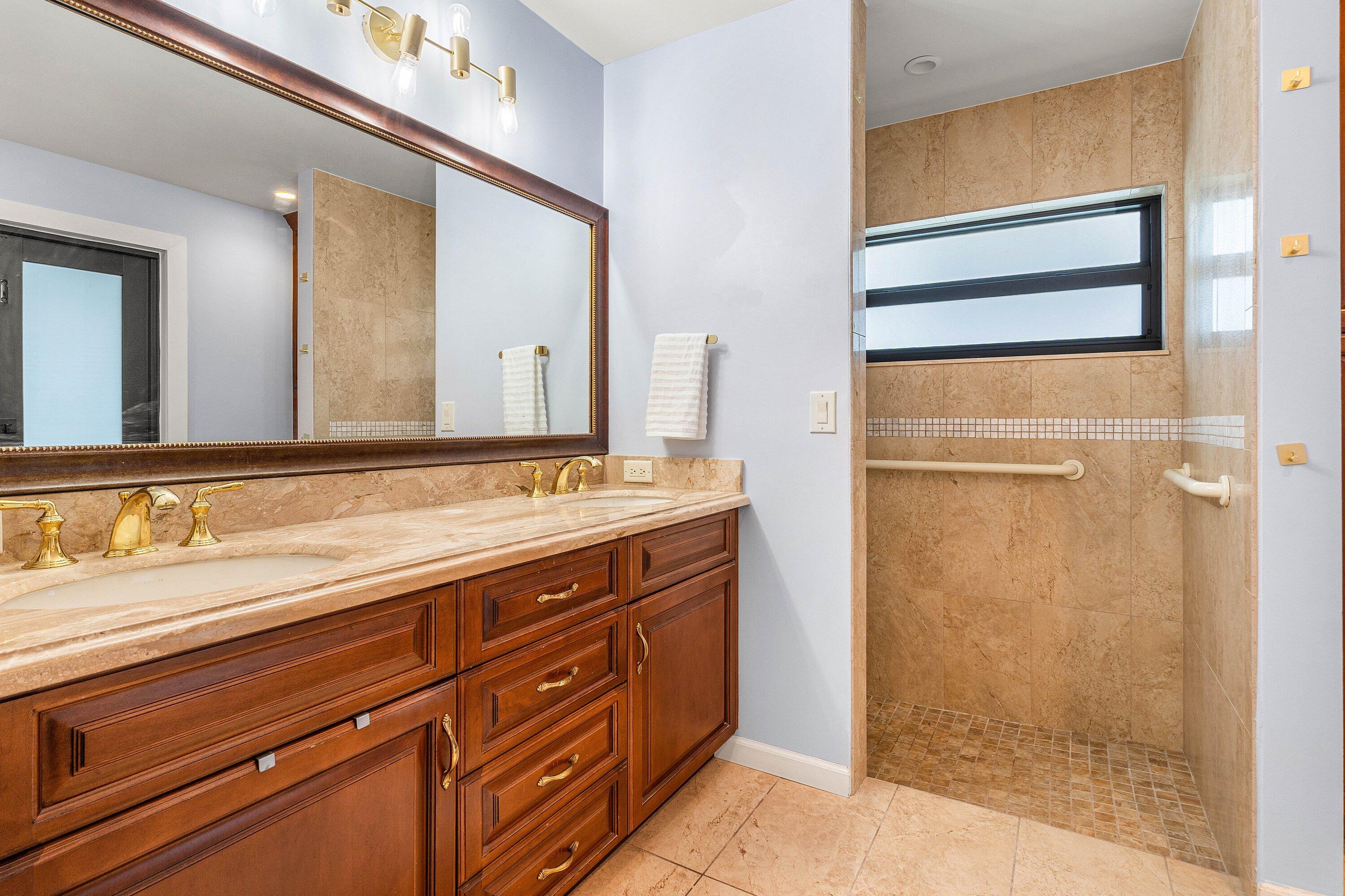 10174 Crosswind Road Boca Raton, FL 33498 - Photo 21 of 45 a bathroom with a granite countertop sink mirror and shower