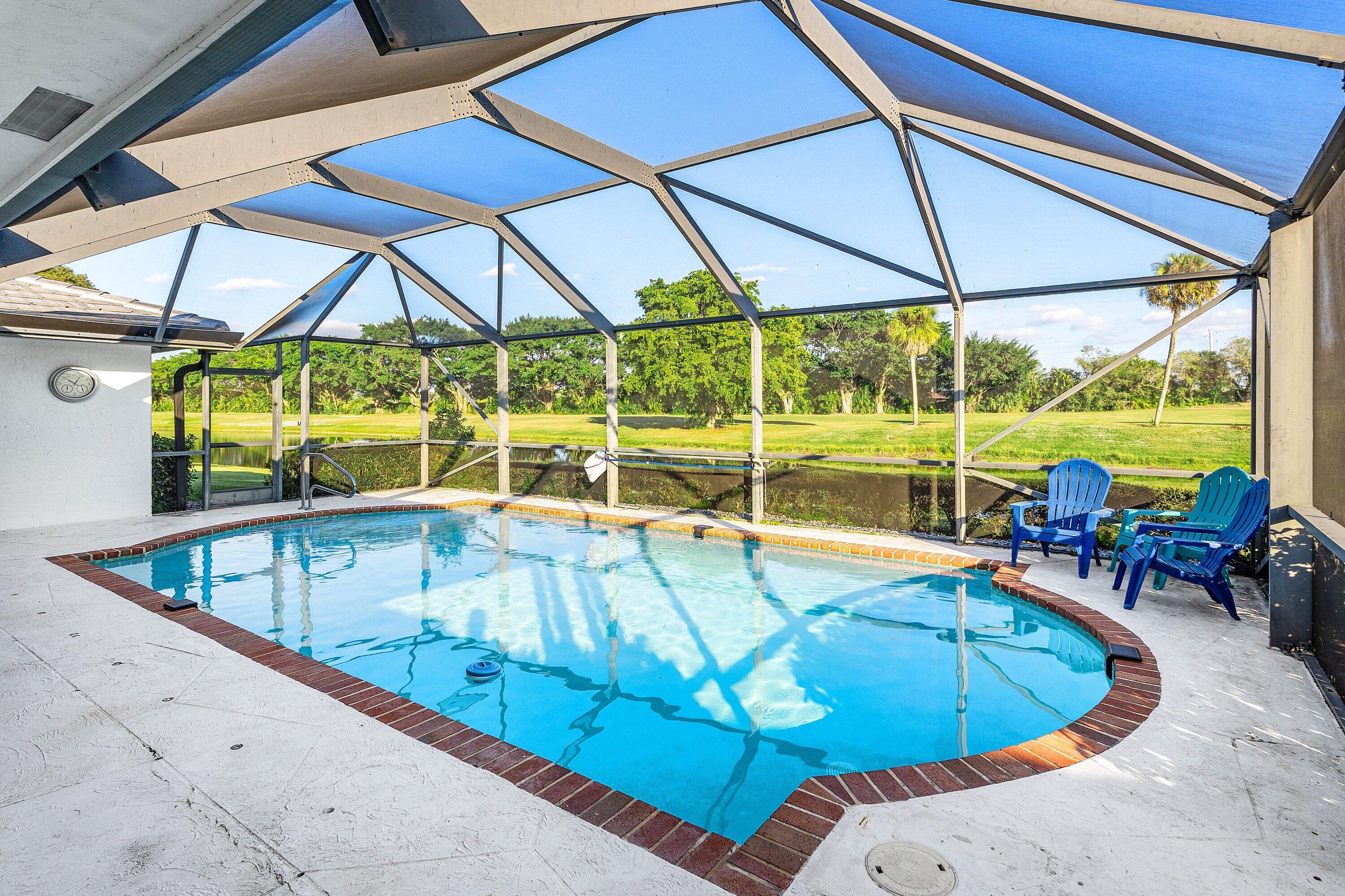 10174 Crosswind Road Boca Raton, FL 33498 - Photo 25 of 45 a view of a swimming pool with a lounge chairs