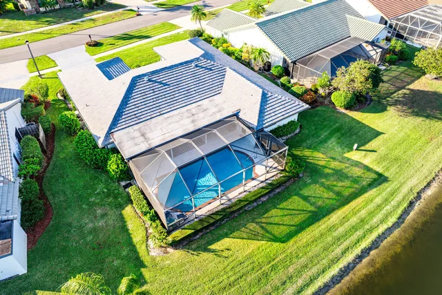 a view of a backyard with plants and a swimming pool