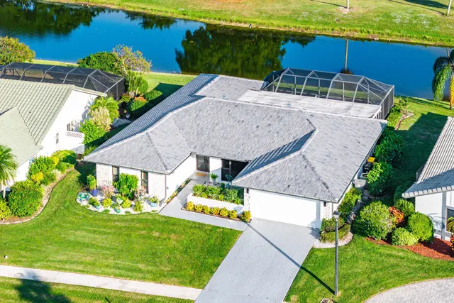 an aerial view of a house with a yard basket ball court and outdoor seating