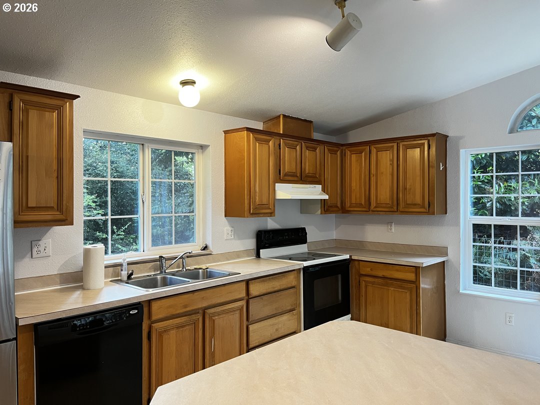 83411 Clear Lake Road Florence, OR 97439 - Photo 12 of 47 a kitchen with a sink stove and cabinets
