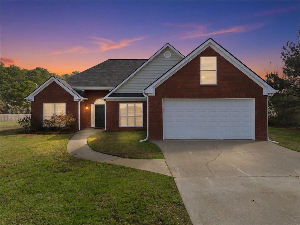 493 Youth Jersey Road Covington, GA 30014 - Photo 2 of 52 a front view of a house with a garden