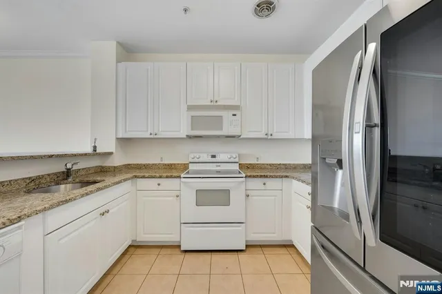 a kitchen with a stove sink and refrigerator