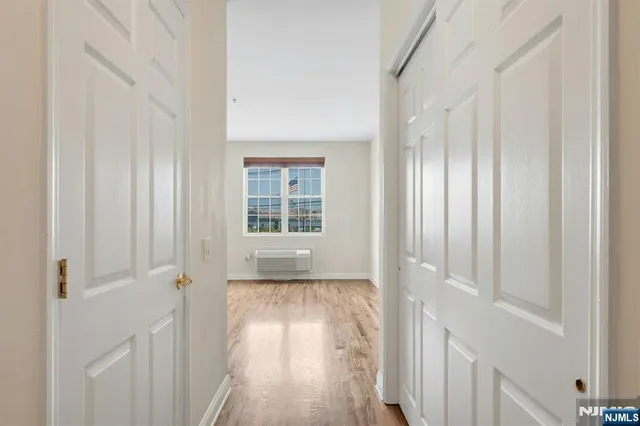 a view of a room with wooden floor and windows