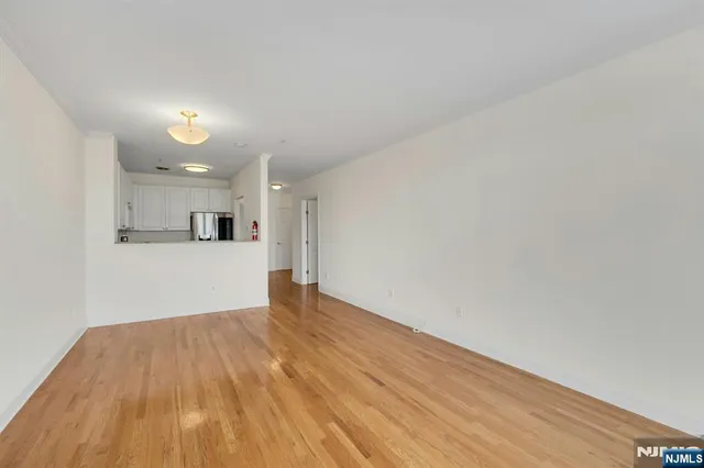 a view of a kitchen with wooden floor and a sink