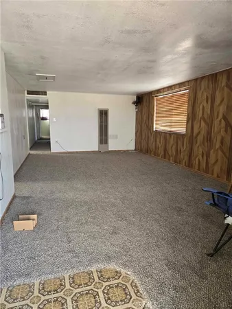 a room with window and refrigerator