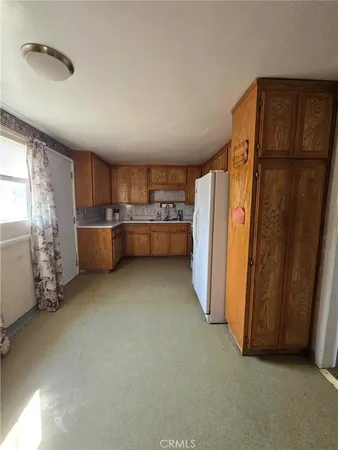 a stove top oven sitting inside of a kitchen