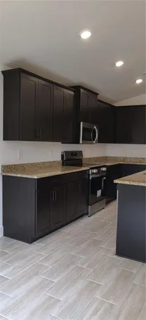 a kitchen with stainless steel appliances wooden cabinets and a sink