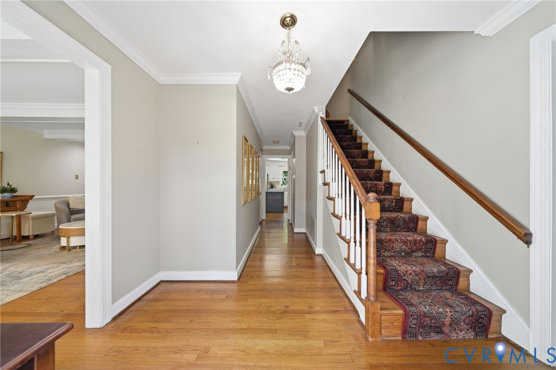 2101 Castlebridge Road Midlothian, VA 23113 - Photo 5 of 37 a view of a hallway with wooden floor and stairs