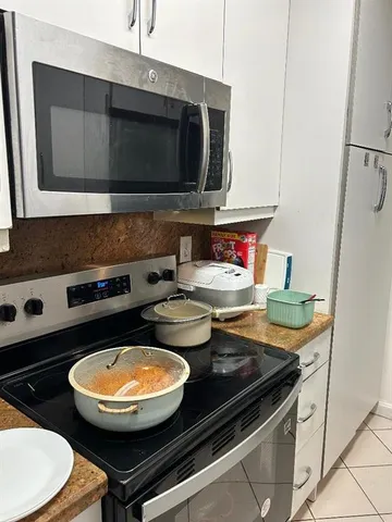a kitchen with a stove and a microwave
