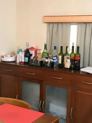 a kitchen with a sink and a stove with wooden floor