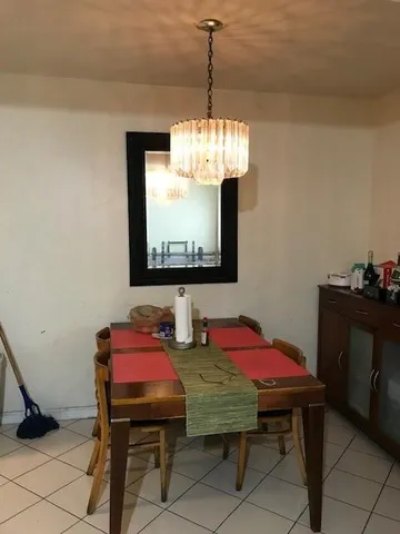 a dining room with furniture and chandelier