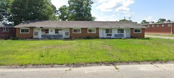 a front view of a house with yard