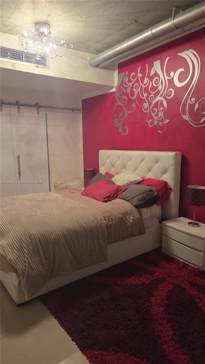 690 Southwest 1st Court, Unit 1722 Miami, FL 33130 - Photo 14 of 35 a bedroom with a bed and a window