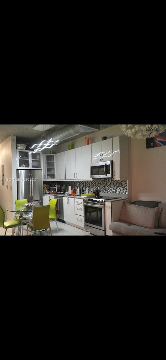 690 Southwest 1st Court, Unit 1722 Miami, FL 33130 - Photo 10 of 35 a kitchen with stainless steel appliances a sink a stove and a refrigerator
