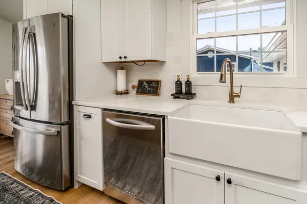 a kitchen with stainless steel appliances a refrigerator and a sink