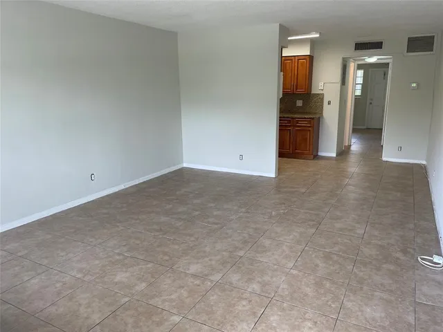 an empty room with closet and windows