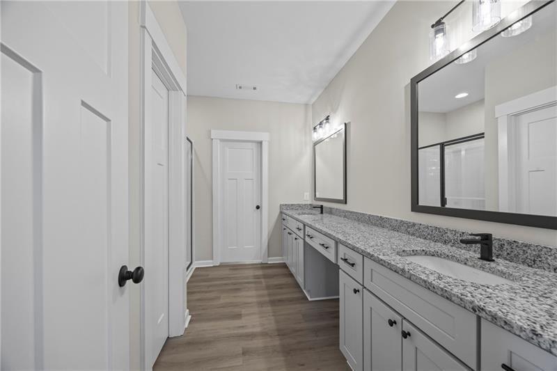 693 Racetrack Road Toccoa, GA 30577 - Photo 27 of 45 a spacious bathroom with a granite countertop sink and a mirror