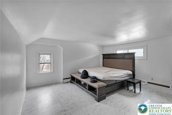 a bedroom with a bed and window