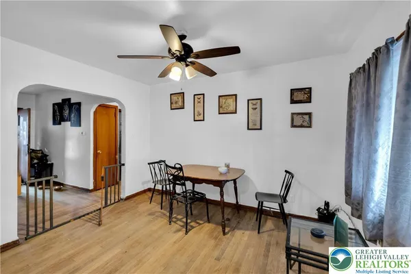 a view of a livingroom with furniture and a workspace