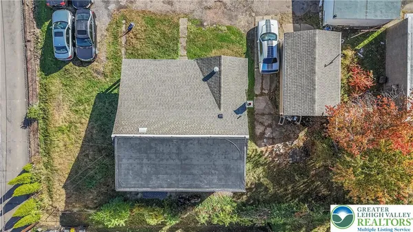 an aerial view of a house with a yard