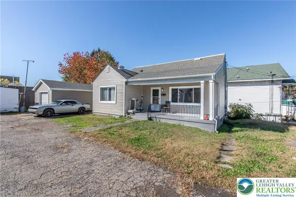 a front view of a house with a garden and porch