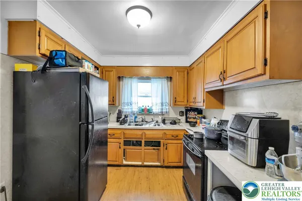 a kitchen with a sink a refrigerator and a stove