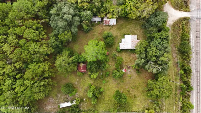 an aerial view of a house with a yard