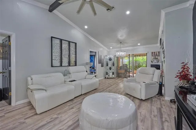 a kitchen with stainless steel appliances granite countertop a refrigerator and wooden floor
