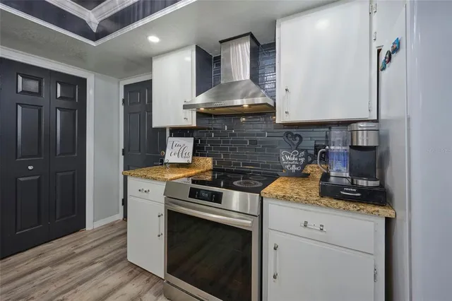 a kitchen with stainless steel appliances granite countertop a stove and a sink