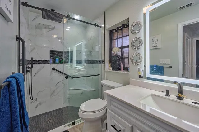 a spacious bedroom with a bed and a large window