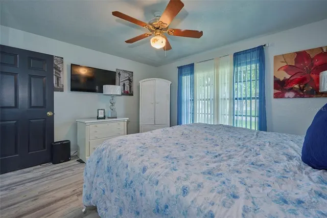 a bedroom with a large bed and a chandelier