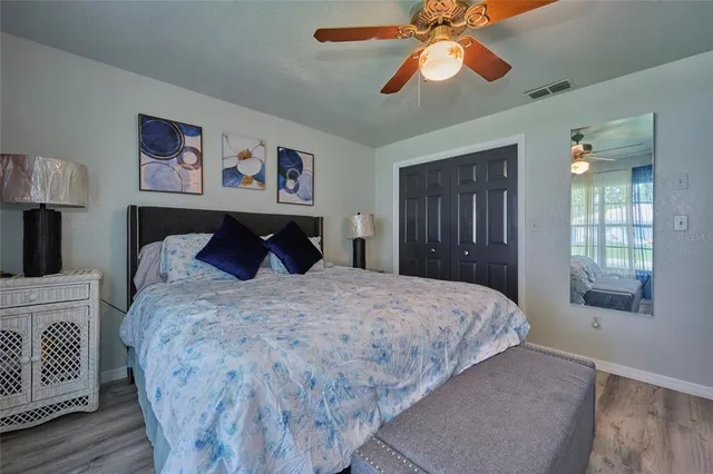 a bedroom with a bed and a television