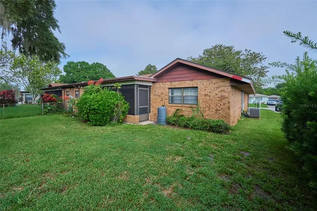 a house with green field in front of it