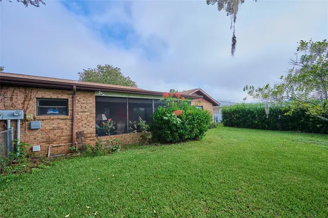 an aerial view of a house with a yard and potted plants