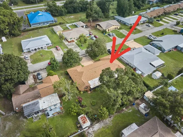an aerial view of residential houses with outdoor space